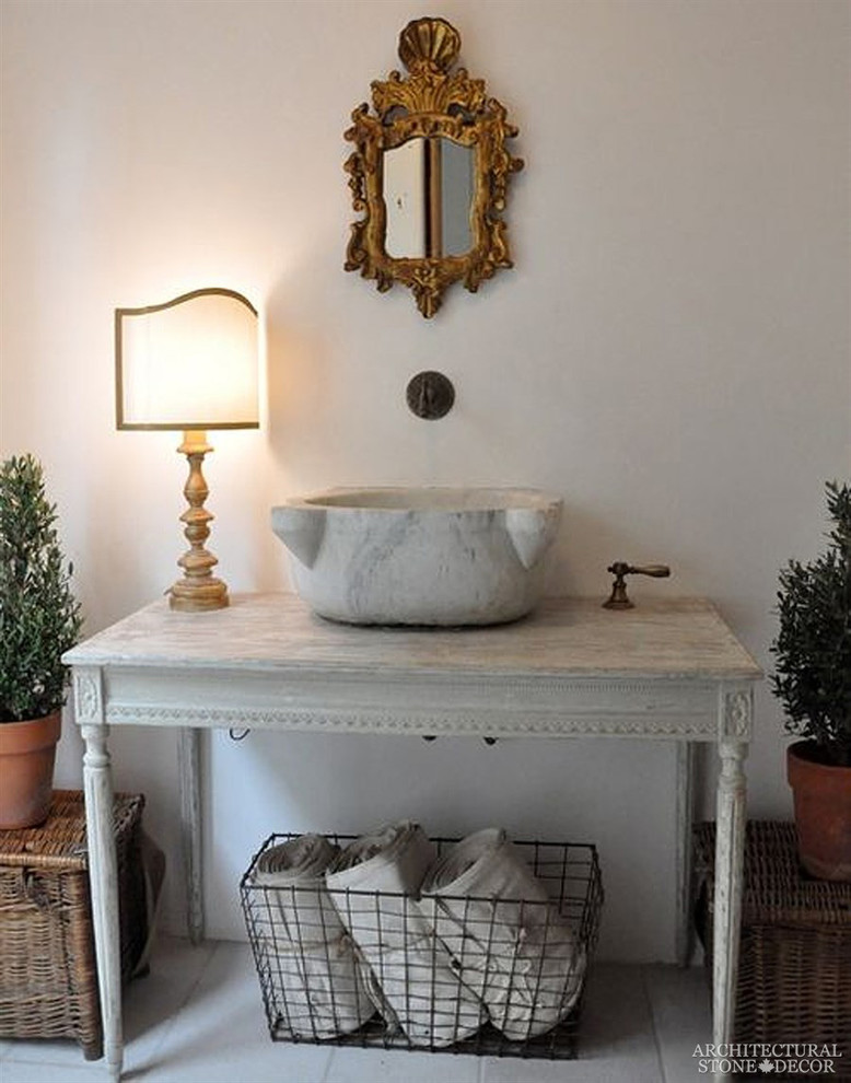 Inspiration for a mid-sized mediterranean powder room in Toronto with gray tile, marble floors, marble benchtops and a vessel sink.