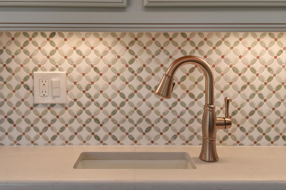 Example of a large transitional u-shaped kitchen design in DC Metro with a farmhouse sink, recessed-panel cabinets, quartz countertops, stainless steel appliances and an island