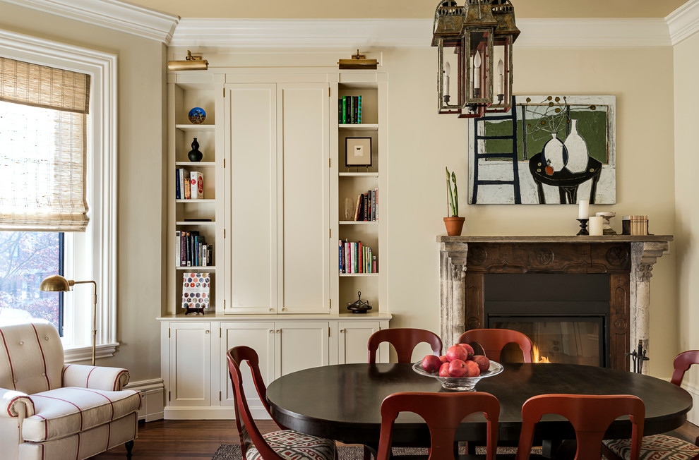 Inspiration for a traditional dining room in Boston with beige walls, dark hardwood floors, a standard fireplace and a wood fireplace surround.