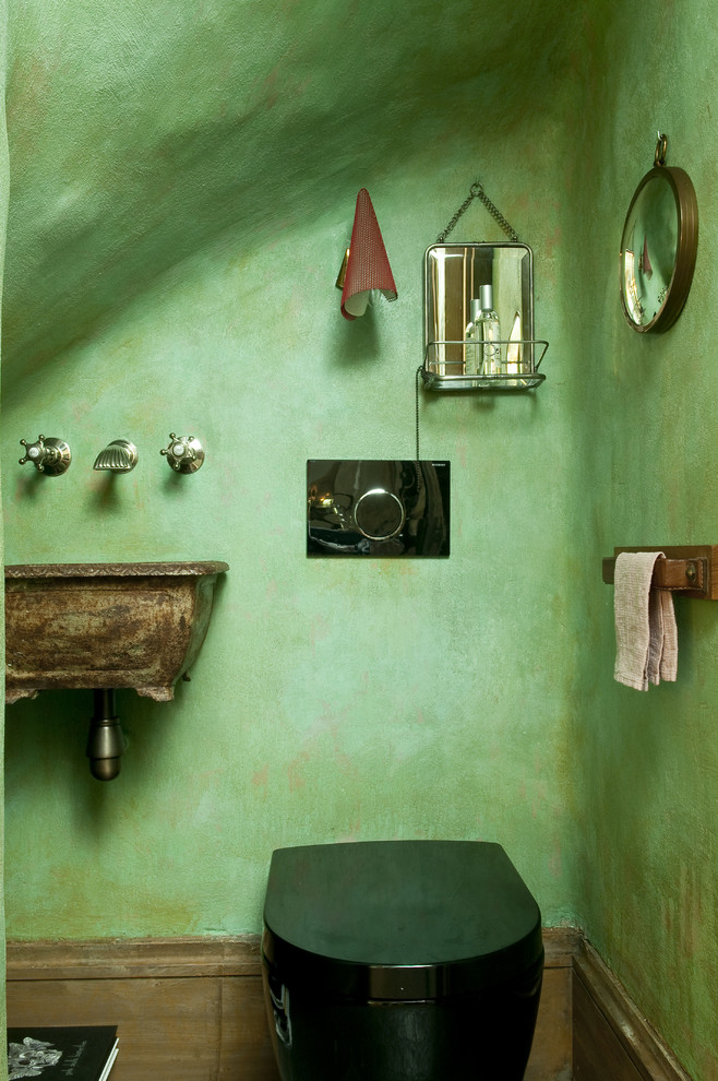 Photo of a mid-sized eclectic powder room in Paris with a wall-mount sink, a wall-mount toilet and green walls.