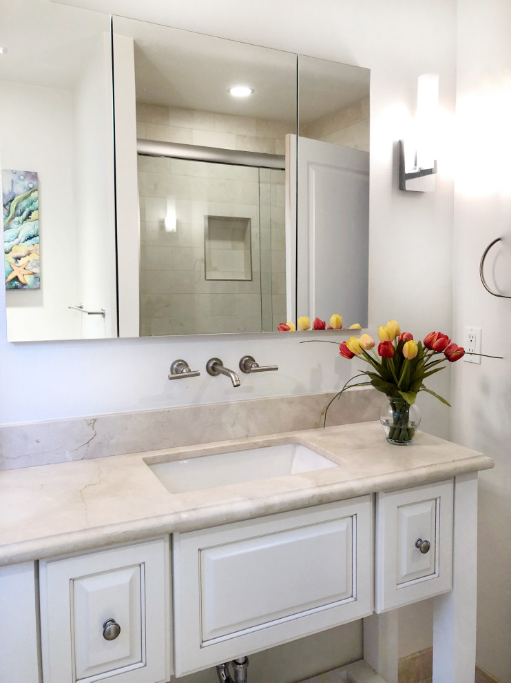 Mid-sized transitional bathroom in Other with raised-panel cabinets, white cabinets, white walls, travertine floors, an undermount sink, quartzite benchtops, beige benchtops, a single vanity and a freestanding vanity.