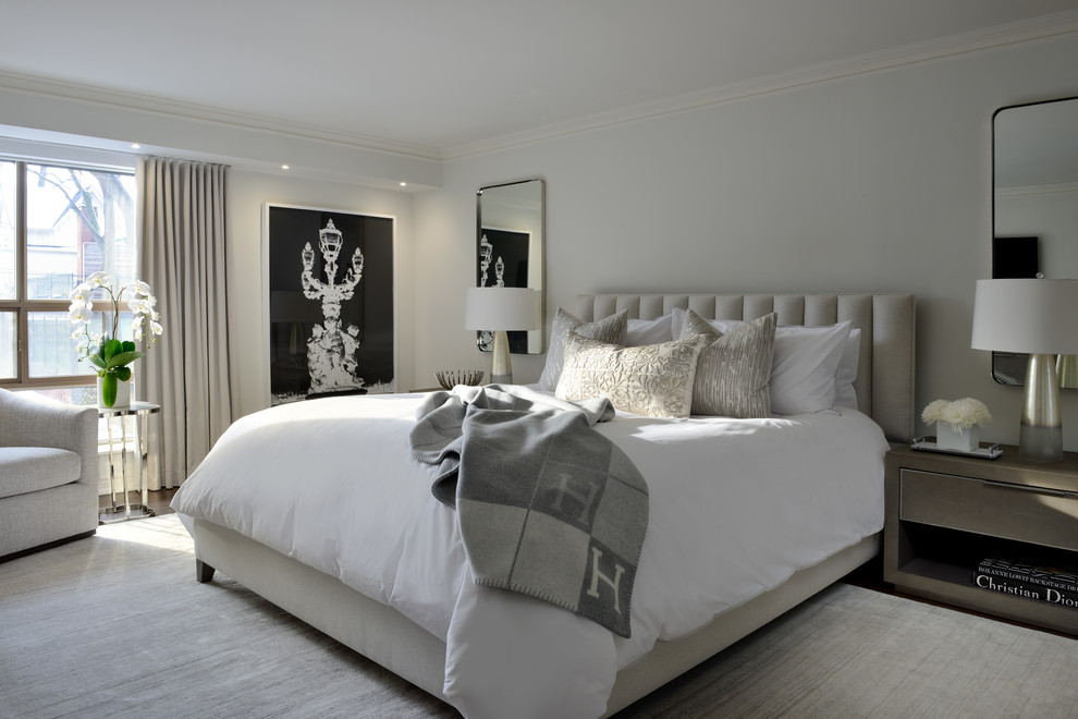 Photo of a transitional master bedroom in Toronto with white walls, dark hardwood floors and brown floor.