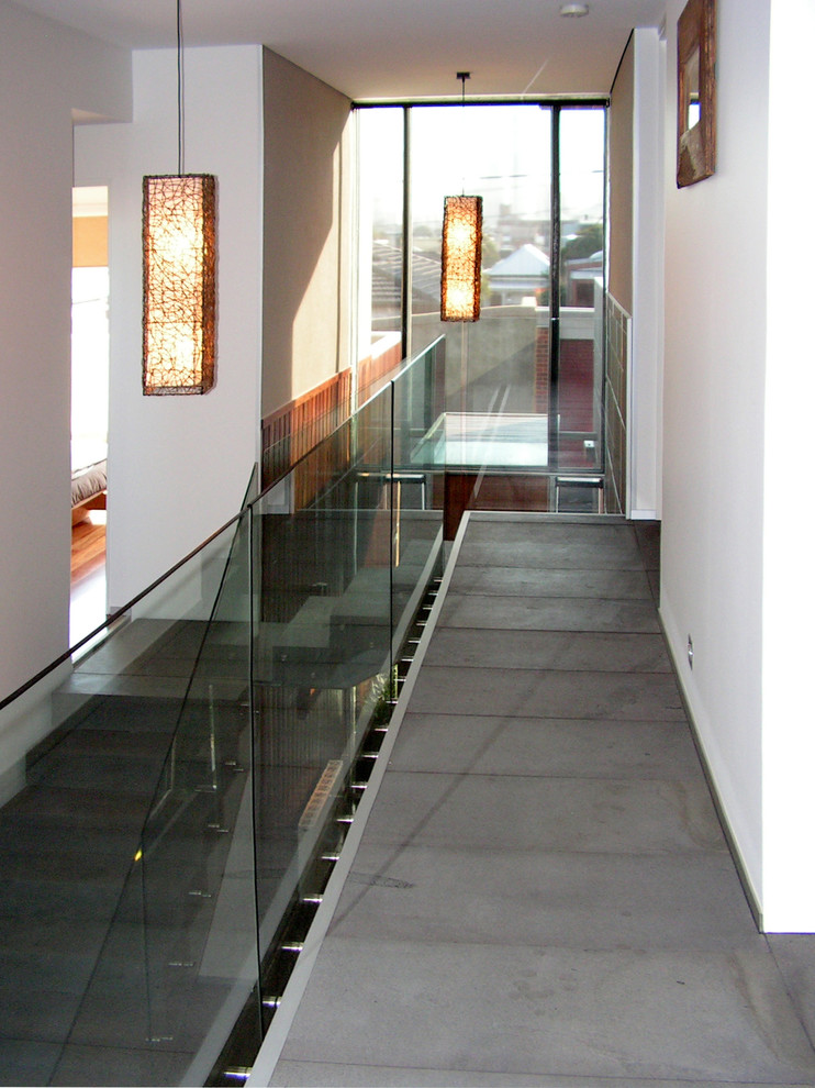 Inspiration for a large l-shaped staircase in Other with glass railing.
