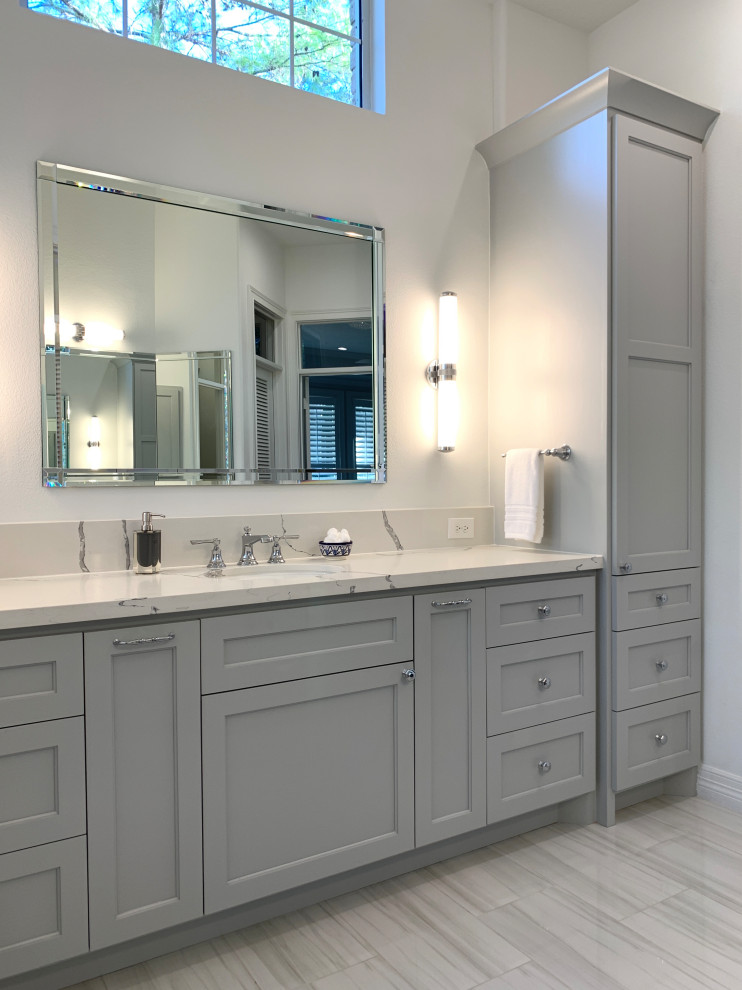 Design ideas for a transitional master bathroom in Houston with shaker cabinets, grey cabinets, a curbless shower, a two-piece toilet, white tile, ceramic tile, white walls, porcelain floors, an undermount sink, engineered quartz benchtops, grey floor, an open shower, white benchtops, a niche, a double vanity and a built-in vanity.