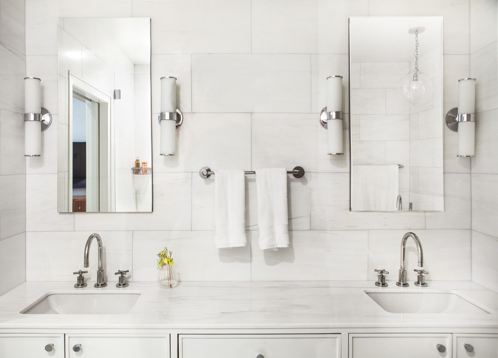 Large contemporary master bathroom with flat-panel cabinets, white cabinets, a freestanding tub, an alcove shower, a one-piece toilet, white tile, marble, white walls, marble floors, an undermount sink, marble benchtops, white floor, a hinged shower door and white benchtops.