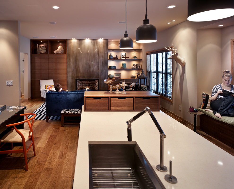 Open concept kitchen - mid-sized transitional medium tone wood floor open concept kitchen idea with an undermount sink, shaker cabinets, white cabinets, quartz countertops, green backsplash, glass tile backsplash, stainless steel appliances, beige walls and an island