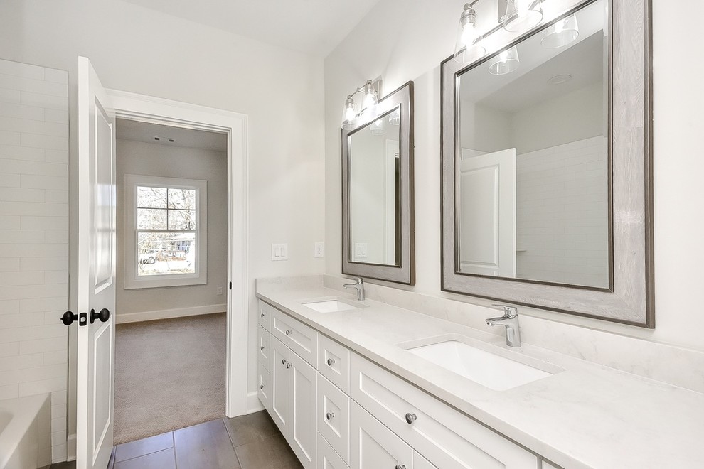 This is an example of a large country 3/4 bathroom in Atlanta with white cabinets, white walls, an undermount sink, quartzite benchtops, grey benchtops, shaker cabinets, porcelain floors and brown floor.