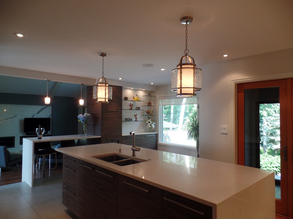 Enclosed kitchen - mid-sized transitional l-shaped porcelain tile and beige floor enclosed kitchen idea with an undermount sink, flat-panel cabinets, medium tone wood cabinets, quartz countertops, white backsplash, subway tile backsplash, paneled appliances and an island