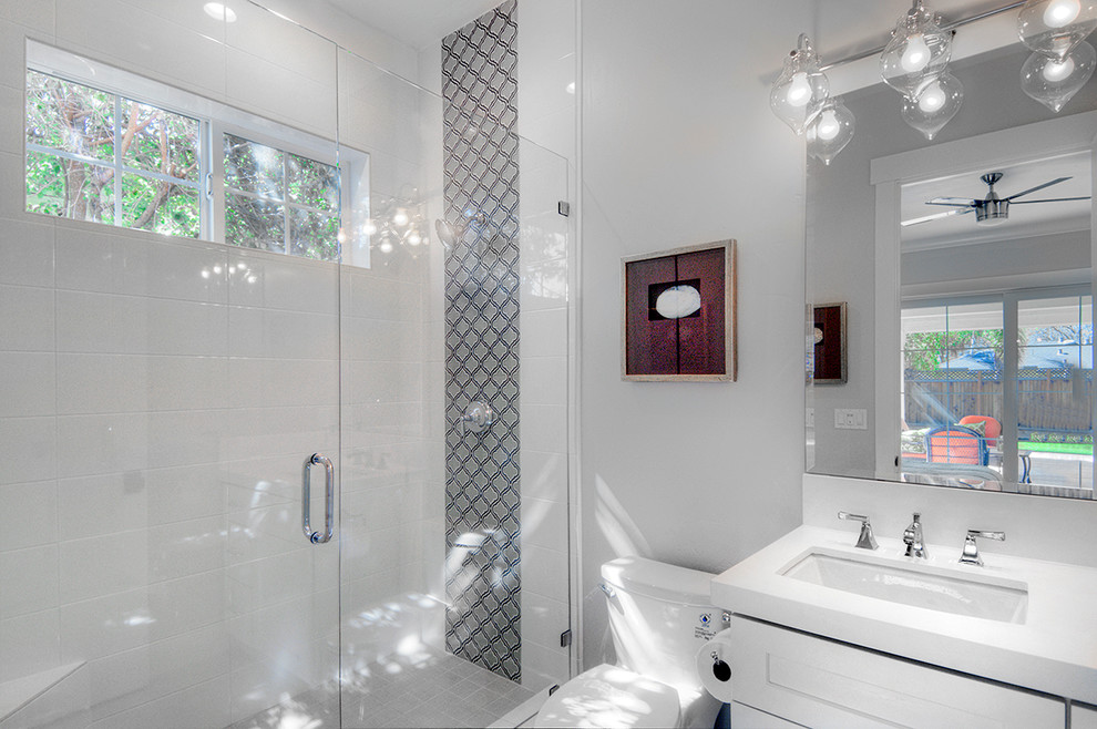 Mid-sized transitional 3/4 bathroom in San Francisco with shaker cabinets, white cabinets, an alcove shower, a one-piece toilet, white tile, ceramic tile, grey walls, ceramic floors, an undermount sink and engineered quartz benchtops.