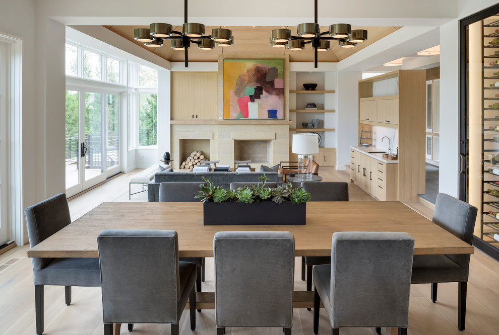Design ideas for an expansive modern open plan dining in Minneapolis with white walls and light hardwood floors.
