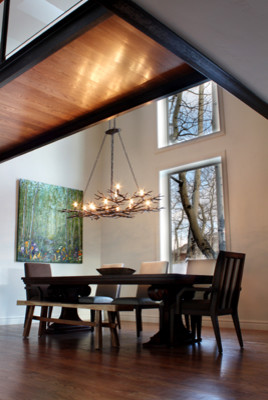 Photo of a mid-sized contemporary open plan dining in Denver with medium hardwood floors, white walls and no fireplace.