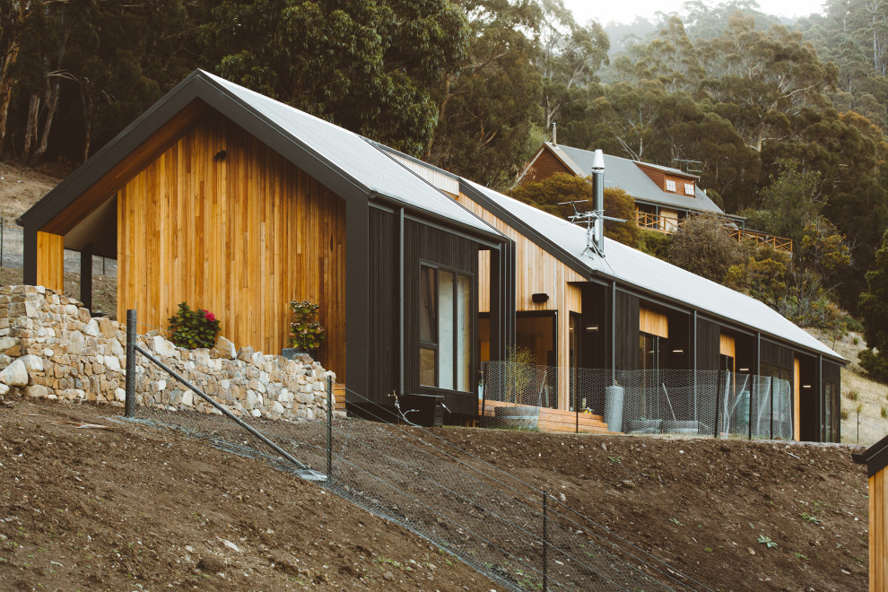 Contemporary house exterior in Hobart with wood siding and a metal roof.