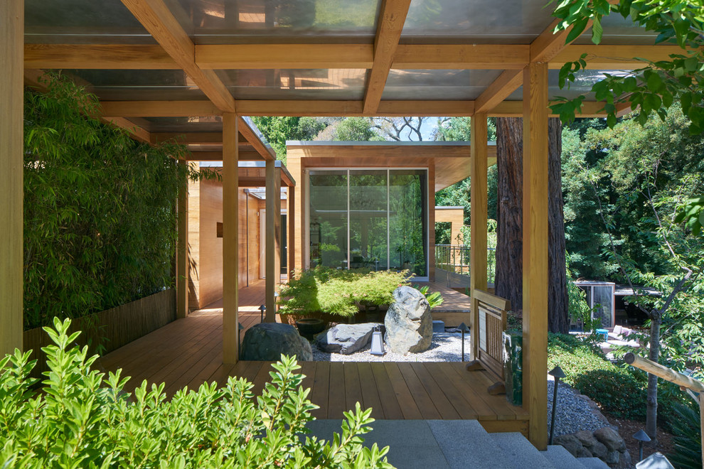 This is an example of a small modern front yard verandah in San Francisco with decking and a pergola.