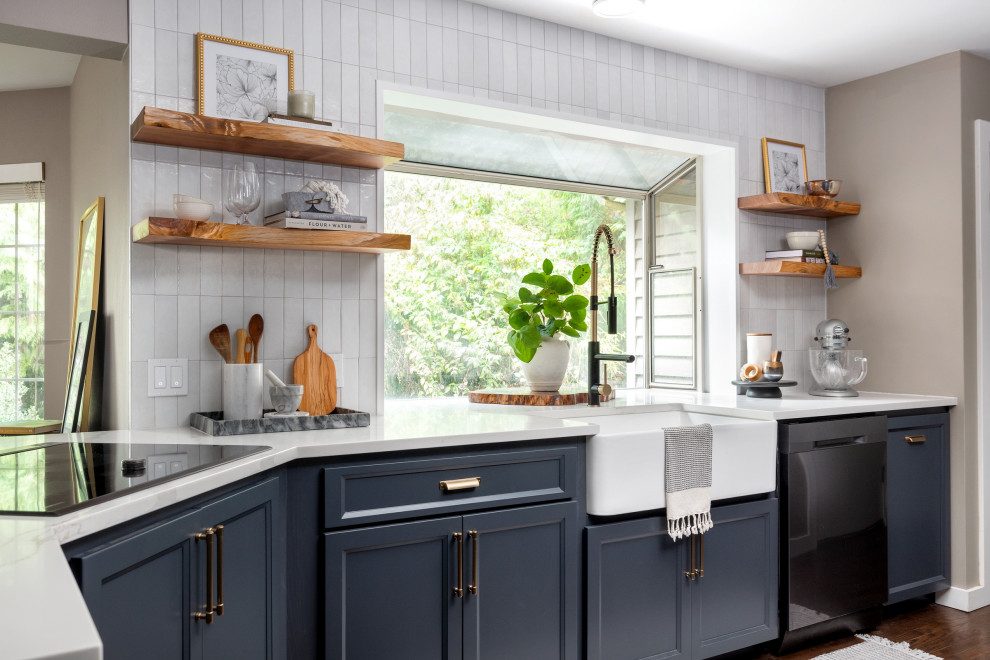 Inspiration for a mid-sized transitional l-shaped dark wood floor eat-in kitchen remodel in Seattle with a farmhouse sink, shaker cabinets, blue cabinets, quartz countertops, white backsplash, porcelain backsplash, stainless steel appliances and a peninsula