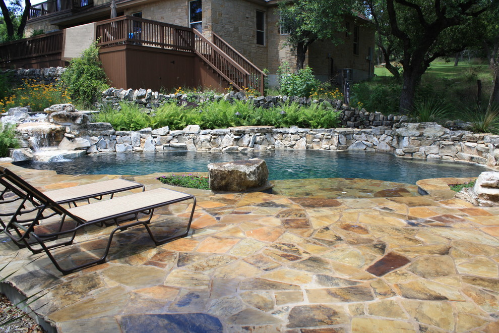 Pool fountain - mid-sized rustic indoor kidney-shaped indoor pool fountain idea in Austin with decking