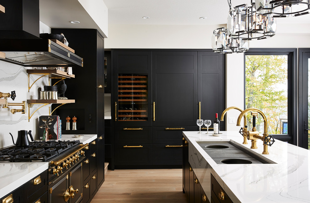 Design ideas for a large transitional open plan kitchen in Minneapolis with an undermount sink, shaker cabinets, black cabinets, quartz benchtops, white splashback, stone slab splashback, panelled appliances, light hardwood floors, with island, yellow floor and white benchtop.