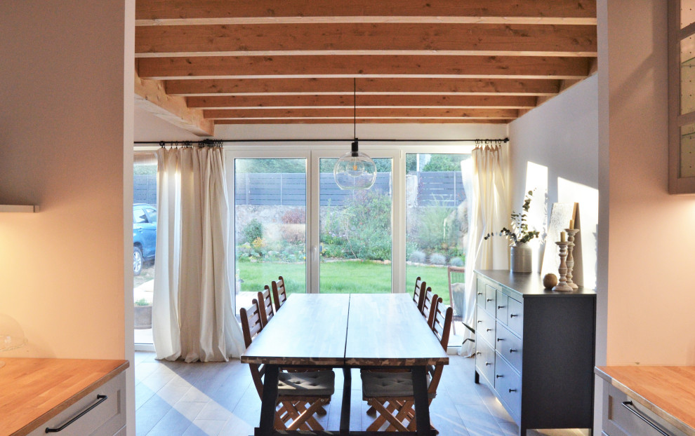 Inspiration for a medium sized scandi dining room in Other with white walls, porcelain flooring and a wood ceiling.