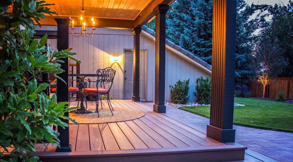 Inspiration for a mid-sized traditional backyard deck in Denver with a roof extension.