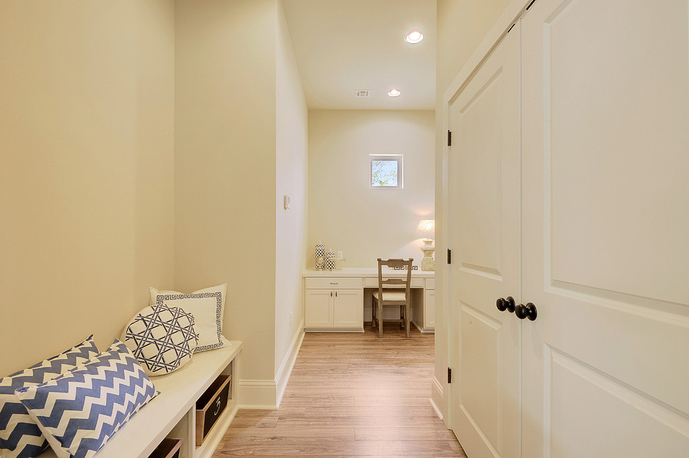 Photo of a mid-sized traditional hallway in New Orleans with white walls and light hardwood floors.