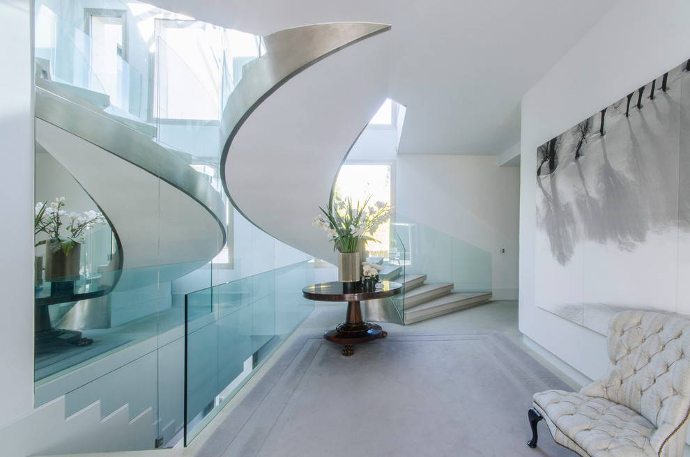 Photo of a mid-sized contemporary concrete spiral staircase in Madrid with concrete risers.