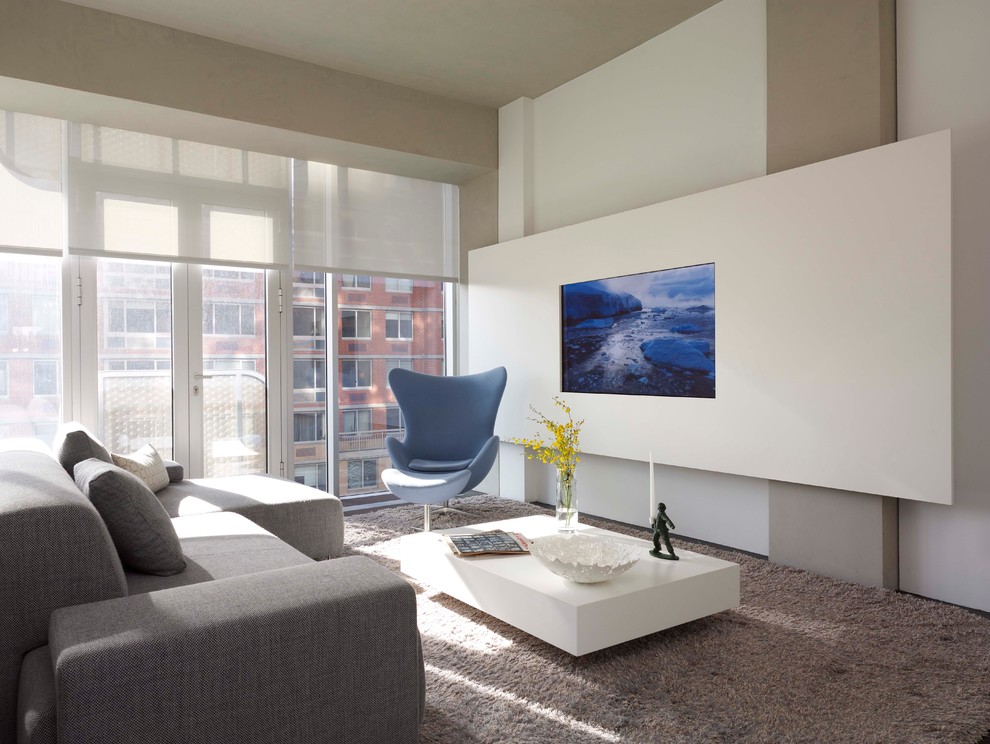 Modern living room in New York with white walls and a wall-mounted tv.