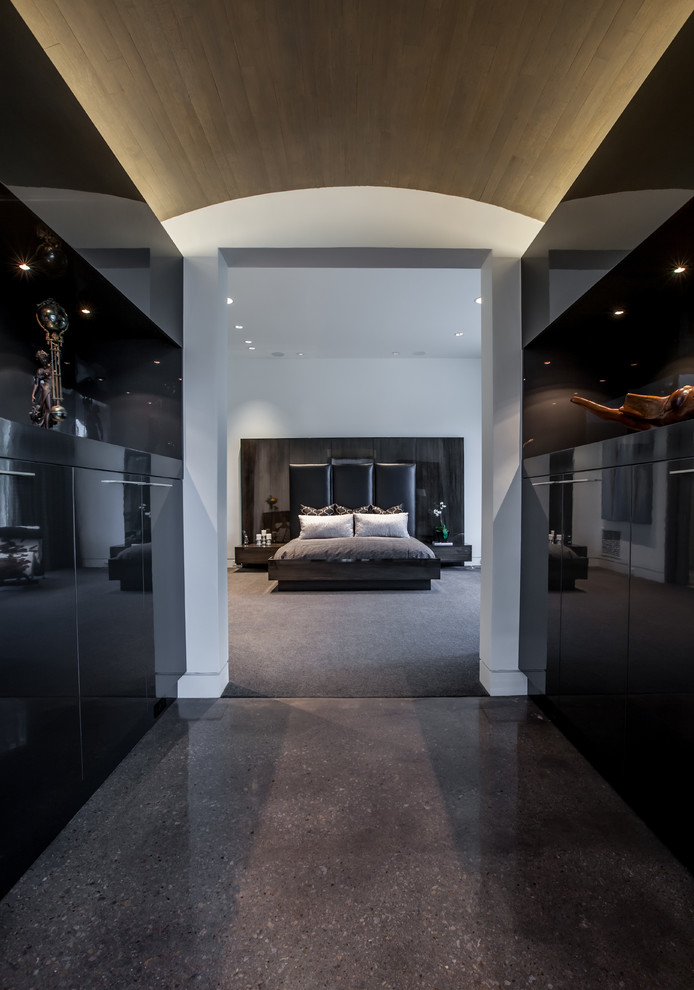 This is an example of a mid-sized contemporary master bedroom in Dallas with black walls and travertine floors.