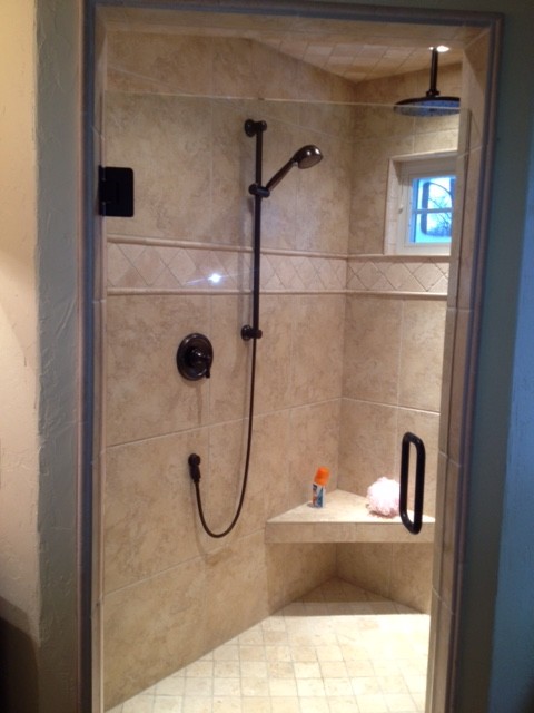 Inspiration for a large transitional master beige tile and ceramic tile ceramic tile alcove shower remodel with beige walls and granite countertops