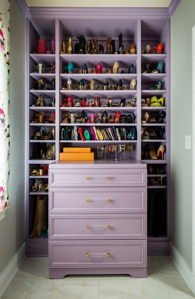 This is an example of a large classic walk-in wardrobe for women in Dallas with recessed-panel cabinets, porcelain flooring and beige floors.