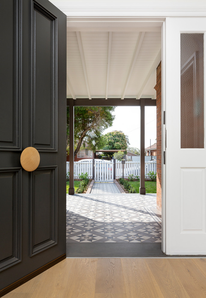 Design ideas for a large victorian front door in Sydney with white walls, medium hardwood floors, a single front door, a black front door and brown floor.