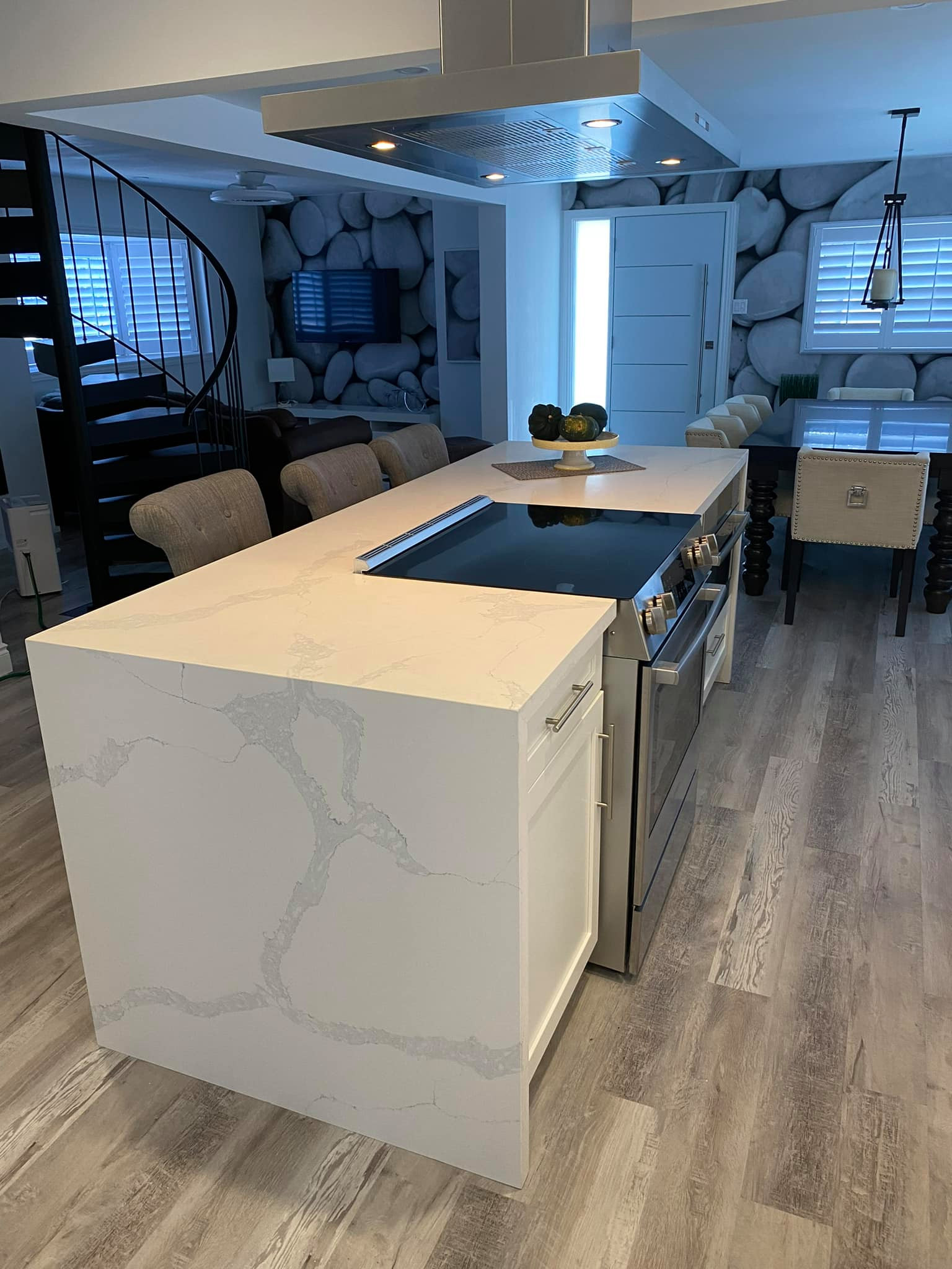 Whole Home Renovation with Quartz Island cooking, seating and Waterfall. Load Bearing Beams, Custom Wall Paper and Spiral Stair Case