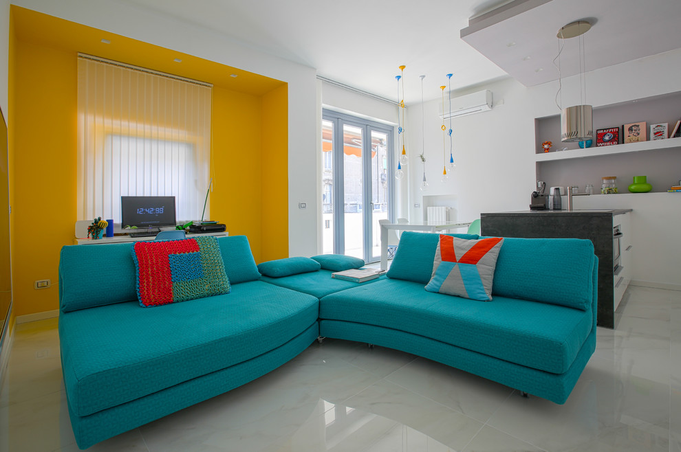 This is an example of a contemporary open concept living room in Milan with yellow walls and grey floor.
