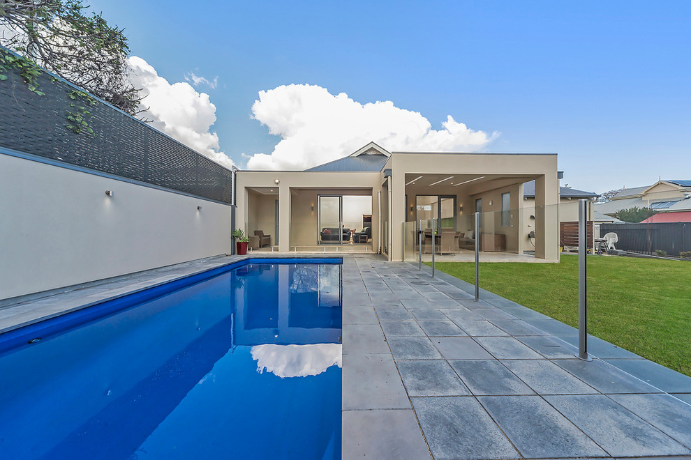 This is an example of a contemporary backyard rectangular lap pool in Adelaide with concrete pavers.