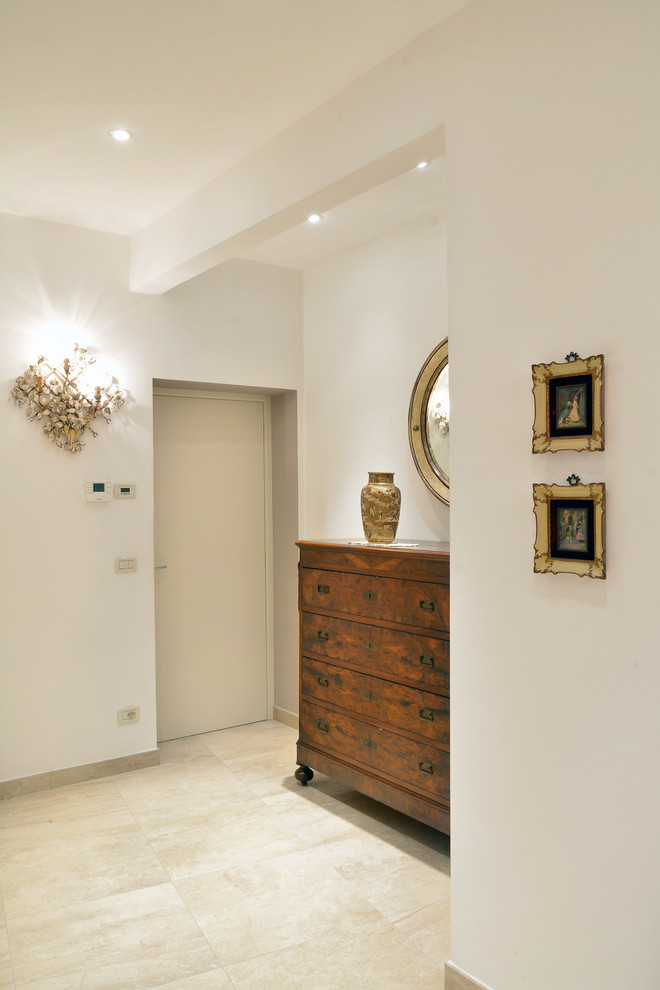 Design ideas for a mid-sized traditional foyer in Bologna with white walls, marble floors and a white front door.