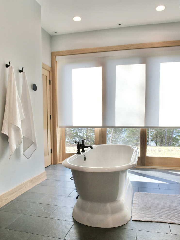 This is an example of an expansive rural ensuite bathroom in Burlington with flat-panel cabinets, light wood cabinets, a freestanding bath, a built-in shower, grey tiles, slate flooring, a console sink, quartz worktops, green floors, an open shower, grey worktops, an enclosed toilet, double sinks and a built in vanity unit.