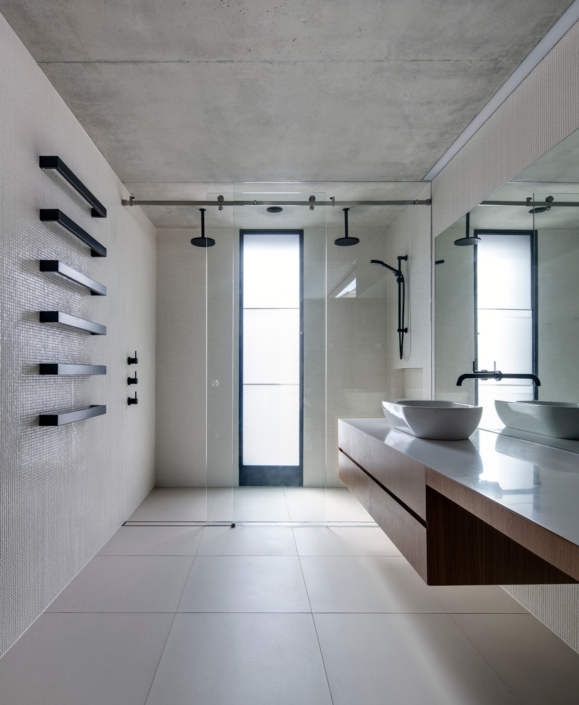 Design ideas for a mid-sized modern bathroom in Sydney with a vessel sink, a double shower, flat-panel cabinets, medium wood cabinets, beige tile, mosaic tile, beige walls and travertine floors.