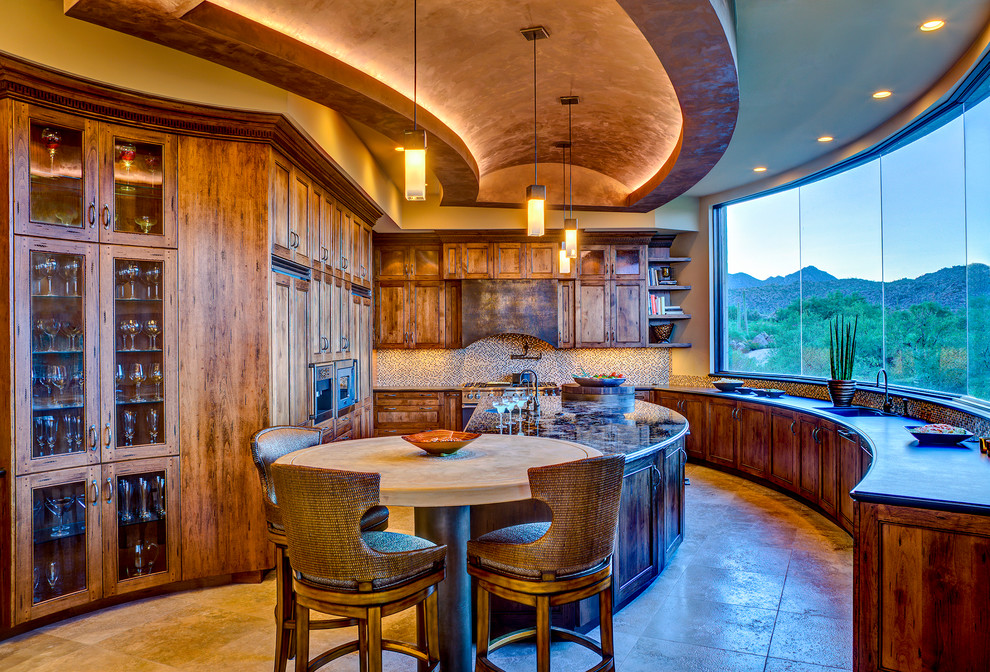 Mountain style kitchen photo in Phoenix with recessed-panel cabinets, medium tone wood cabinets, brown backsplash and stainless steel appliances