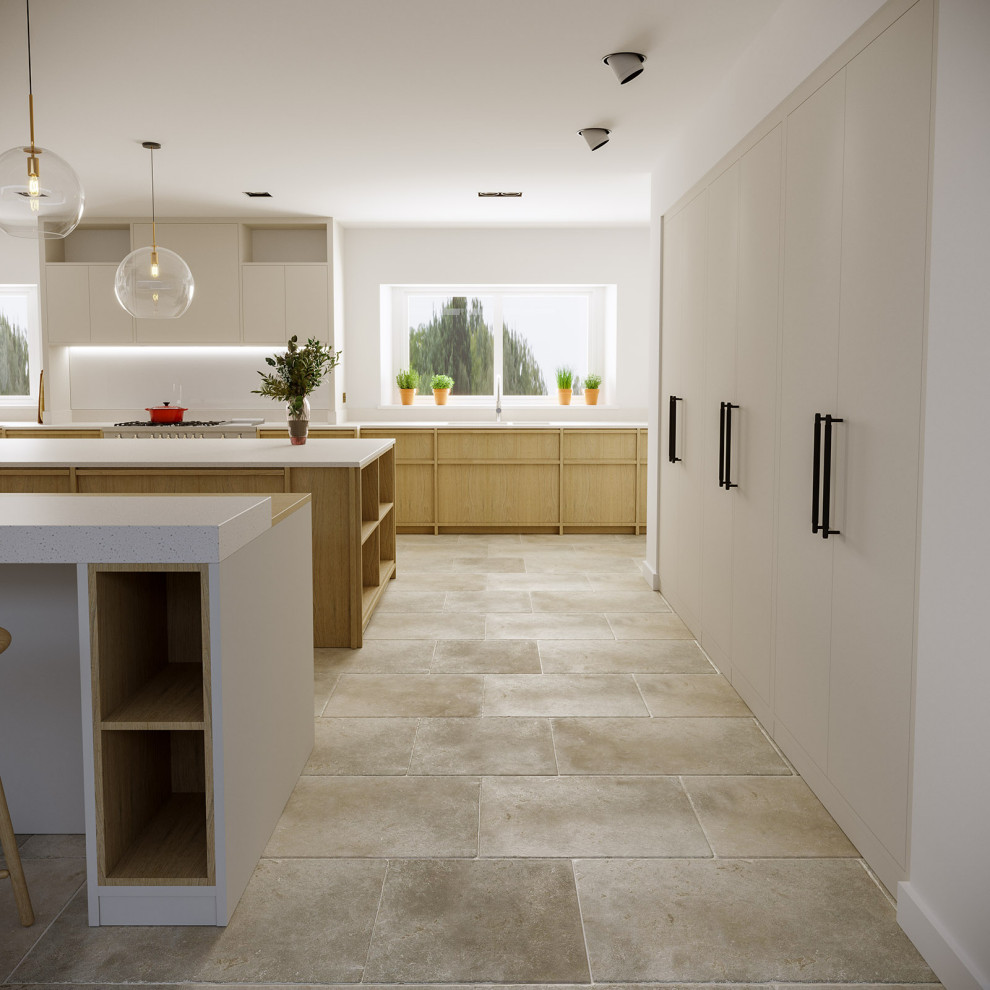 Photo of a large traditional open plan kitchen in Oxfordshire with an integrated sink, flat-panel cabinets, light wood cabinets, composite countertops, white splashback, glass sheet splashback, stainless steel appliances, limestone flooring, multiple islands, beige floors and white worktops.