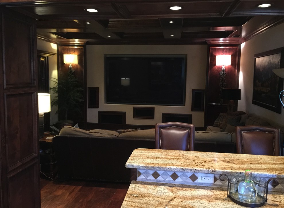Design ideas for a mid-sized country open concept home theatre in Austin with beige walls, medium hardwood floors and a built-in media wall.