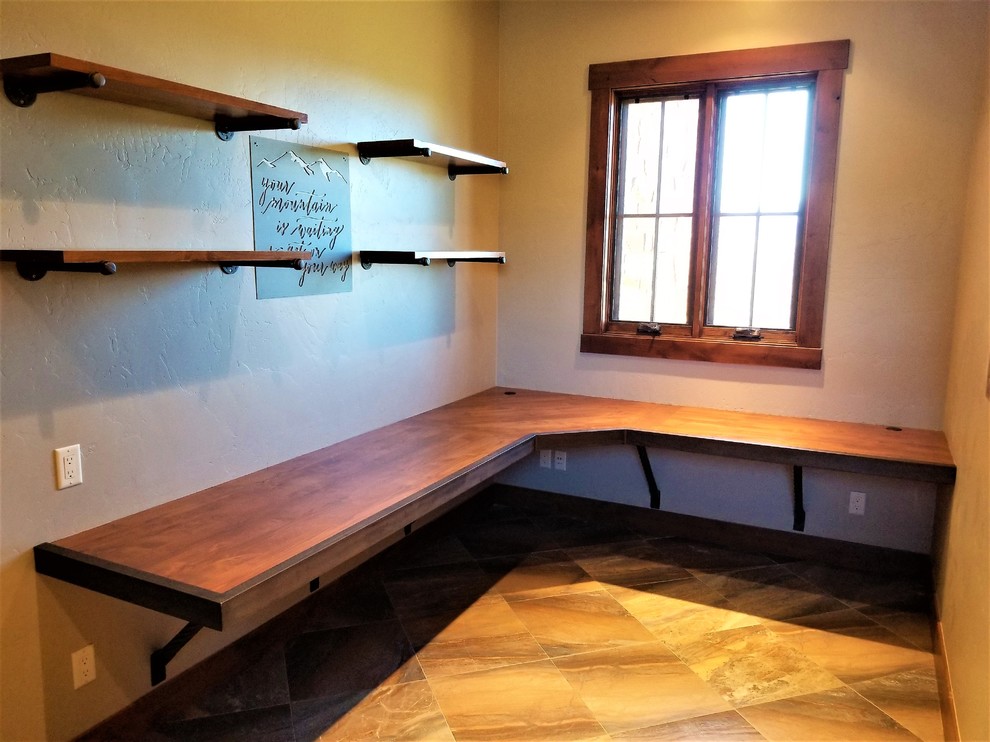 Mid-sized industrial study room in Denver with beige walls, ceramic floors, a built-in desk and multi-coloured floor.