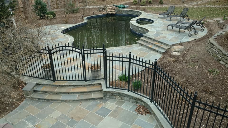 Example of a huge transitional backyard stone and kidney-shaped natural pool design