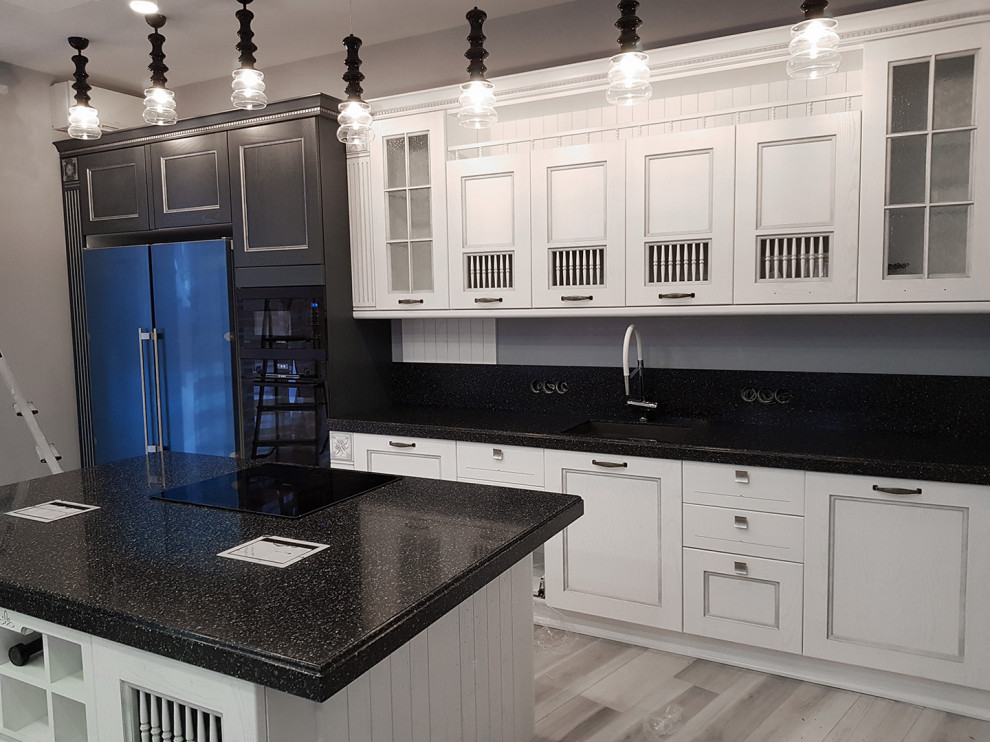 This is an example of a large contemporary galley kitchen/diner in Saint Petersburg with composite countertops, black splashback, an island and black worktops.