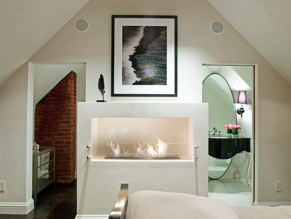 Photo of a contemporary bedroom in San Francisco with a standard fireplace and a plaster fireplace surround.