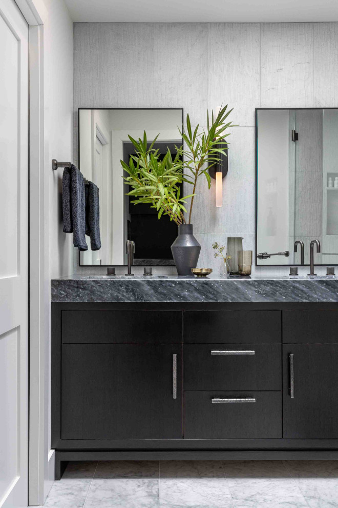 This is an example of a contemporary bathroom in San Francisco with flat-panel cabinets, black cabinets, a wall mounted toilet, black tiles, marble tiles, white walls, marble flooring, a submerged sink, marble worktops, white floors, a hinged door, grey worktops, double sinks and a built in vanity unit.
