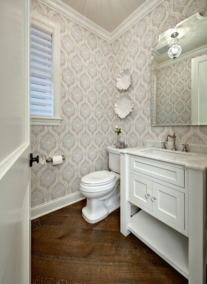 This is an example of a traditional powder room in Minneapolis with an undermount sink, white cabinets and recessed-panel cabinets.