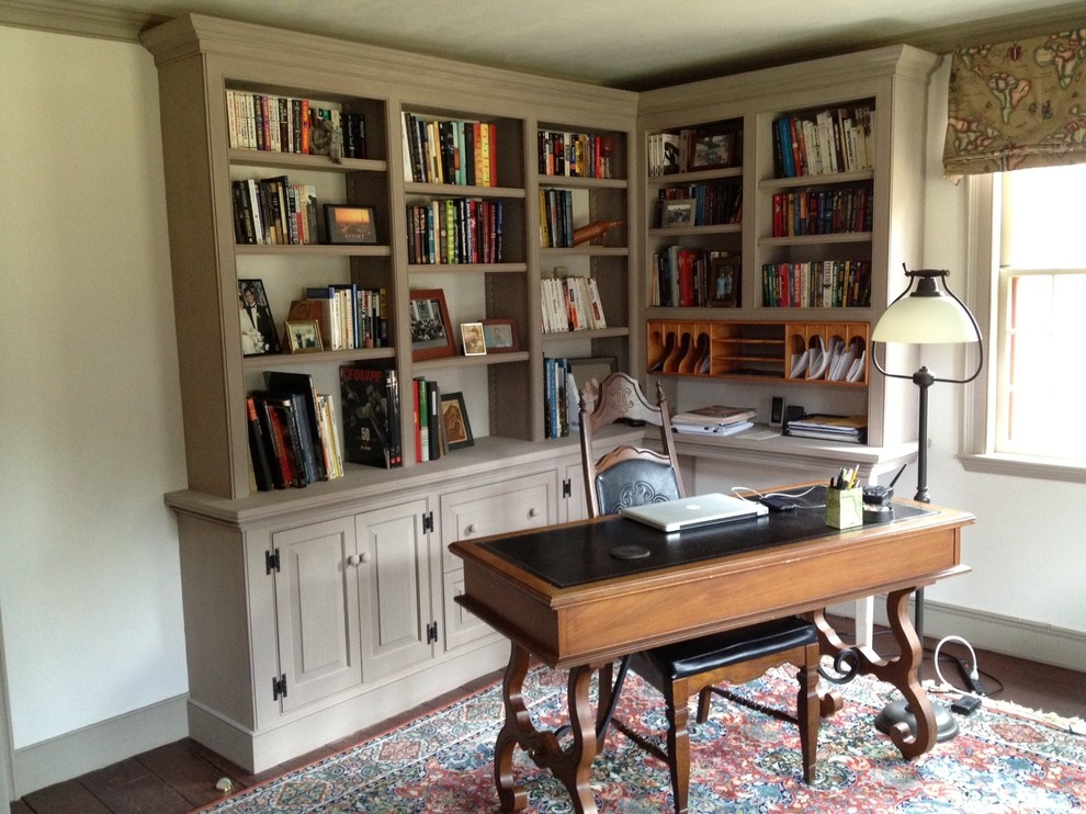 Inspiration for a mid-sized traditional home office in Burlington with a library, white walls, dark hardwood floors and a freestanding desk.