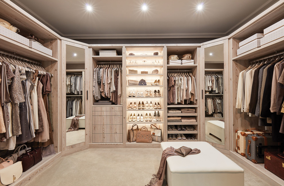 This is an example of a large contemporary walk-in wardrobe with flat-panel cabinets, light wood cabinets, beige floor and carpet.