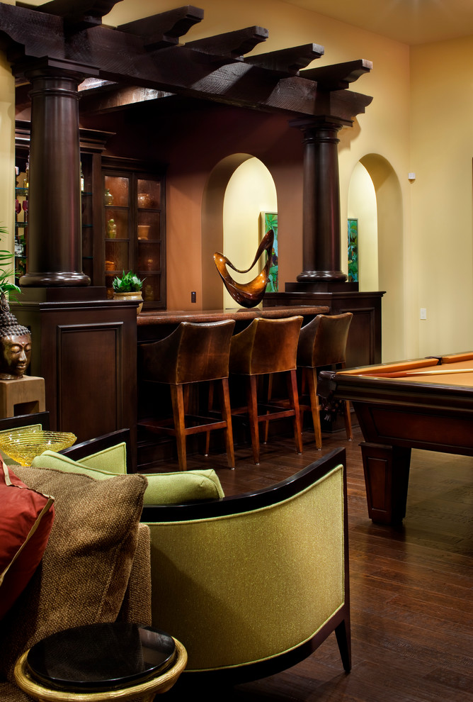 This is an example of a mediterranean galley seated home bar in Austin.