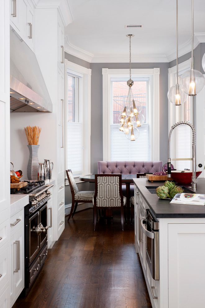 Design ideas for a large transitional galley eat-in kitchen in DC Metro with a single-bowl sink, shaker cabinets, white cabinets, soapstone benchtops, white splashback, stone slab splashback, black appliances, dark hardwood floors and with island.