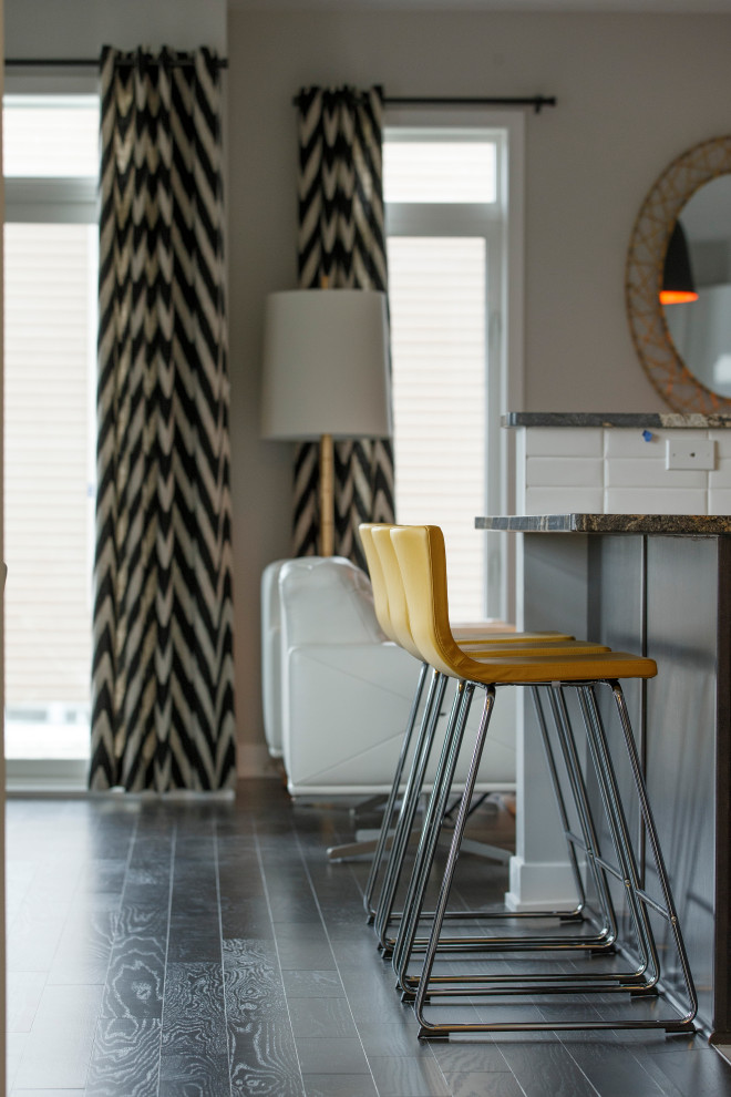 Inspiration for a small transitional u-shaped porcelain tile and gray floor open concept kitchen remodel in Ottawa with an undermount sink, flat-panel cabinets, white cabinets, granite countertops, white backsplash, subway tile backsplash, stainless steel appliances, a peninsula and black countertops
