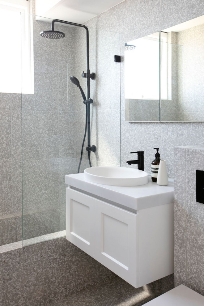 Photo of a small modern bathroom in Sydney with shaker cabinets, white cabinets, a shower/bathtub combo, a wall-mount toilet, gray tile, porcelain tile, grey walls, porcelain floors, engineered quartz benchtops, grey floor, an open shower, white benchtops, a single vanity and a floating vanity.
